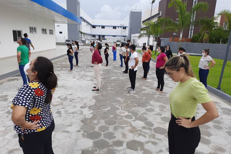 Colaboradores realizando ginástica laboral ao ar livre