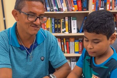 Pai e filho dividem desfrutam de momentos na biblioteca